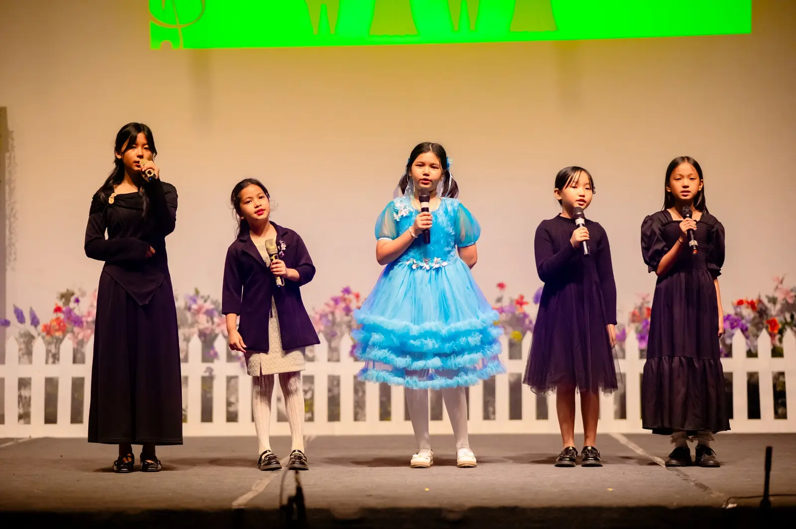 Grace Academy students performing with microphones on stage