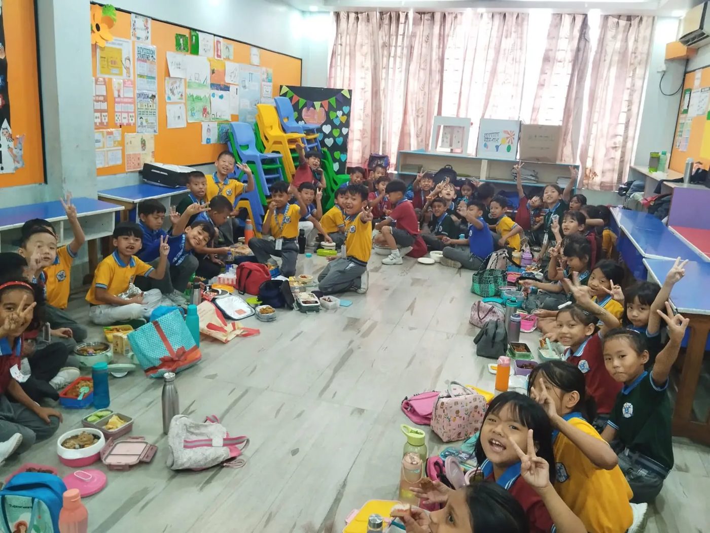 Class 2 students sharing tiffin before the summer break